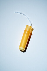 Women protection. Female yellow tampon with applicator on white background. - obrazy, fototapety, plakaty