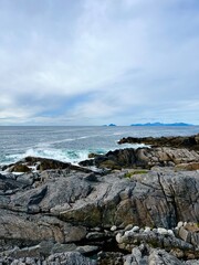 Amazing rocky ocean bay, rocky coast, huge stones, seascape, cloudy sky, Nordic seascape