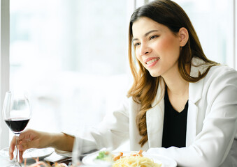 Man and woman, romance people in love having romantic dating valentine day celebration in luxury restaurant. Happy young couple sitting together dining and drinking wine to celebrate an anniversary.