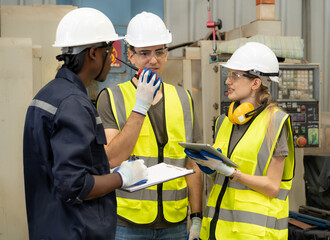 Male industrial engineer manager working with engineering team at production factory in safety equipment technology. Manufacturing technician meeting brainstorming with colleague at workshop facility