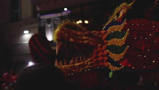 A group of people perform a traditional lion dance parade in Chinatown to celebrate the traditional Chinese Lunar New Year Festival Dragon Dance