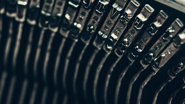 Letters and numbers in the typo keys of a old typewriter typing on a retro writing machine, close up