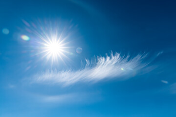 Fototapeta na wymiar Clouds in the blue sky. Bright midday sun illuminates the space.