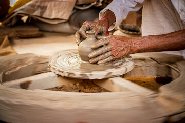 Potter at work makes ceramic dishes. India, Rajasthan.
