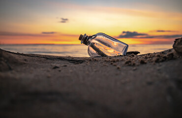 Message in the bottle against the Sun setting down