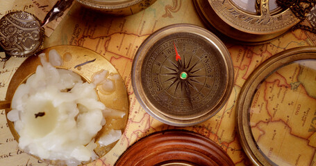 Vintage style travel and adventure. Vintage old compass and other vintage items on the table.