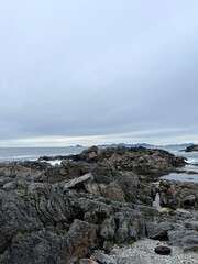 Amazing rocky ocean bay, rocky coast, huge stones, seascape, cloudy sky, Nordic seascape
