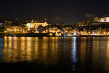 Night scene, Porto Portugal, with reflections in the river Douro.