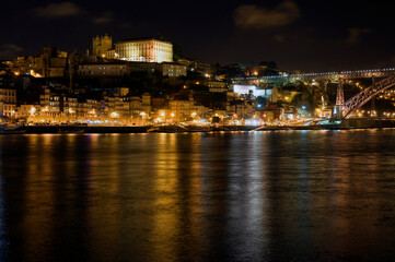 Fototapeta na wymiar Night scene, Porto Portugal, with reflections in the river Douro.