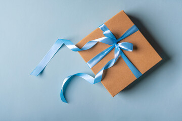 Stylish gift box on a blue background. There is space for text.
