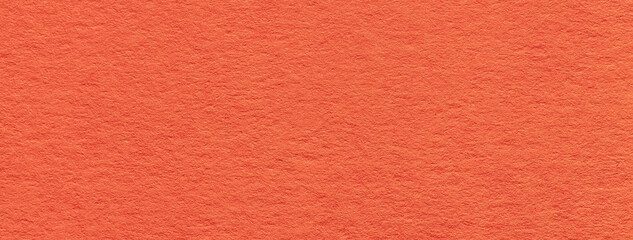Texture of old bright orange color paper background, macro. Structure of a vintage craft ginger cardboard.