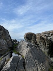 Amazing rocky ocean bay, rocky coast, huge stones, seascape, cloudy sky, Nordic seascape