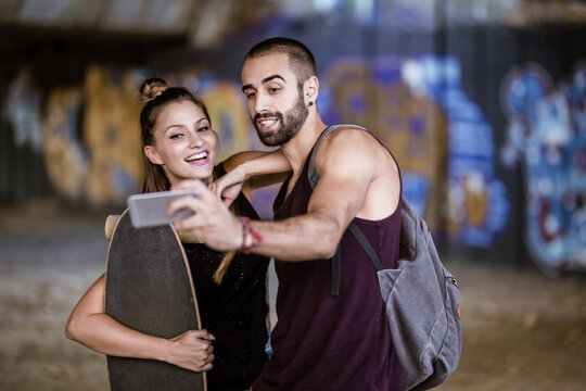 Man and woman taking a selfie and smiling at the camera