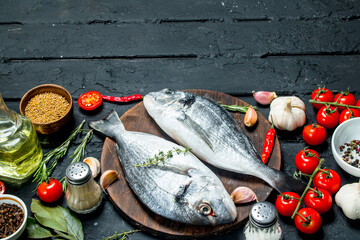 Raw sea fish dorado with spices and vegetables.