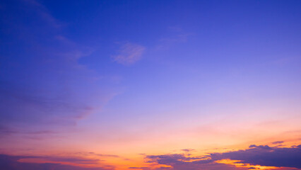 Naklejka na ściany i meble Colorful dusk sky with yellow sunlight and Sunset cloud on dark blue Twilight sky background