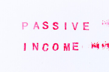 Red color ink rubber stamp in word passive income on white paper background