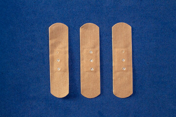 Group of first aid plasters isolated on blue background