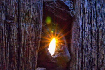 Sunbeams shining through a hole in the buoy. On the beach of the Baltic Sea