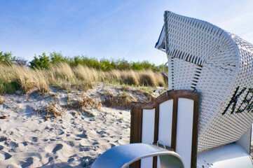 Beach chair on the beach of the Baltic Sea in Zingst. Sun, blue sky. Dune in the background