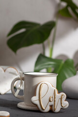 A cup and gingerbread cookies are ready for Valentine's Day