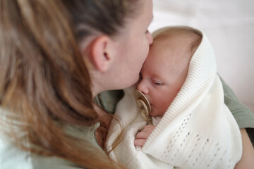 Cropped shot of a mother tenderly caressing her baby