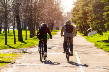 Cyclists ride on the bike path in the city Park
