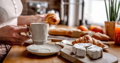 Coffee cup and croissants at kitchen table
