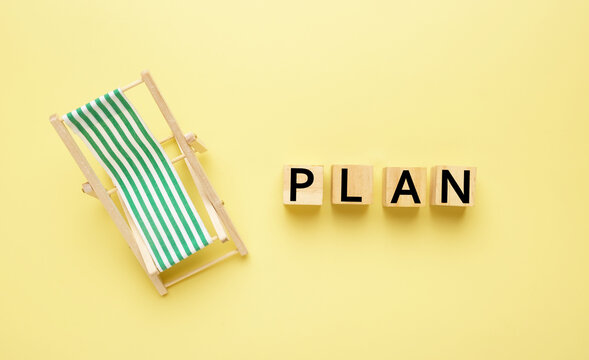 Flatlay picture of folding bench chair with wooden block written plan. Retirement and vacation plan