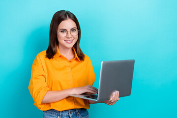 Photo of intelligent gorgeous woman with straight hairdo wear yellow shirt hold laptop distance...