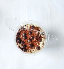 Pudding in a plastic container on a white background. Great for food, pudding, cooking, healthy, breakfast, healthy, liquid, hot, cup, backdrop and more.