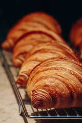 Close-up of fresh and beautiful croissants in a bakery showcase.