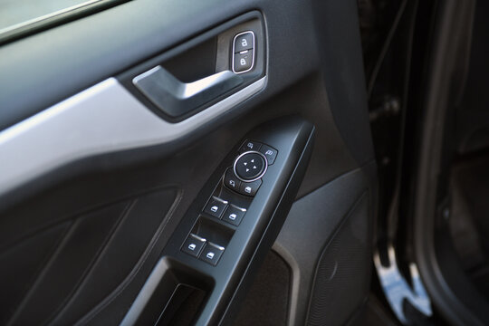 Close-up of side door buttons: window adjustment buttons, door lock. modern car interior: details, buttons, knobs