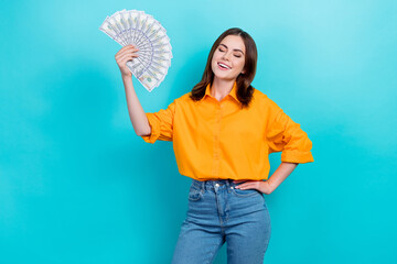 Photo pretty lovely satisfied woman straight hairdo wear yellow shirt use dollars as fan arm on...