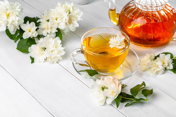 Jasmine tea in a cup on a wooden background. Copy space