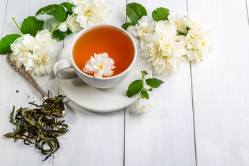 Jasmine tea in a cup on a wooden background. Copy space.