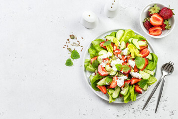 Keto strawberry cucumber feta cheese salad. Top view, copy space, flat lay.