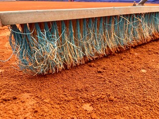 Tennis smoothing Court Broom or brush close up on on clay court. Maintenance equipment for cleaning...