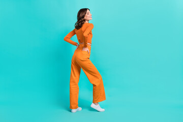 Full length profile side photo of pretty positive lady dressed fashionable clothes empty space isolated on cyan color background