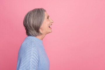 Profile photo of old aged positive woman pensioner laughing funny joke looking empty space information comic show isolated on pink color background