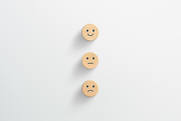 Customer service evaluation and satisfaction survey concepts. Happy face smile face icon on wooden cube, white background