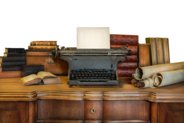 Old wooden desk with vintage typewriter holding an empty sheet of paper and ancient books and maps