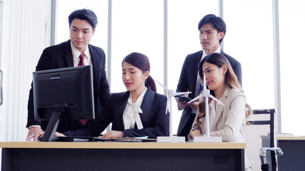 Young female employee working at a desk using a laptop business idea.
