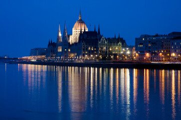 the Parliament Building at night, Budapest, Hungary, with lights reflected in the Danube.