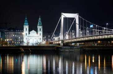 The inner city parish church and Elizabeth Bridge in Budapest at night