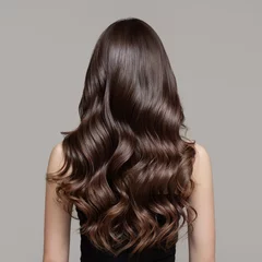 Portrait of a beautiful girl with luxurious curly long hair. Back view. © yuriyzhuravov