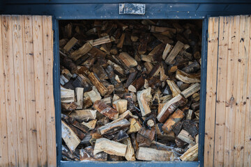 Pile of firewood inside a woodshed