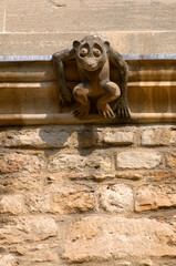 carved gargoyle on the wall of an Oxford college.