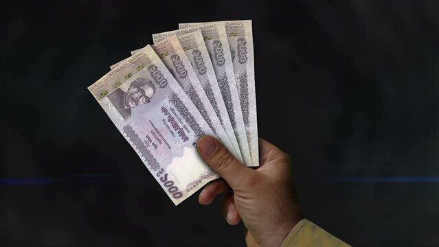 Bangladesh Taka money holding. Fan of banknotes in hand. BDT paper cash. Concept of income, success, business, tax, economy and finance.