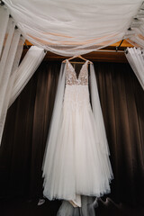 Fashionable beautiful classic lace brides dress in room. morning preparation wedding concept. vintage gown.