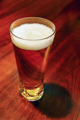 a glass of beer on a table in a restaurant